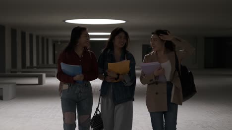 three asian girl students talking while walking through campus