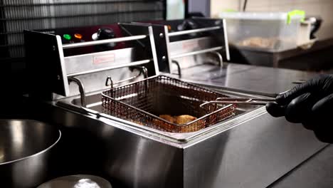 food being fried in a commercial deep fryer