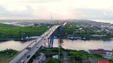 aerial parallax around queen juliana bridge, willemstad curacao as cars and boats commute