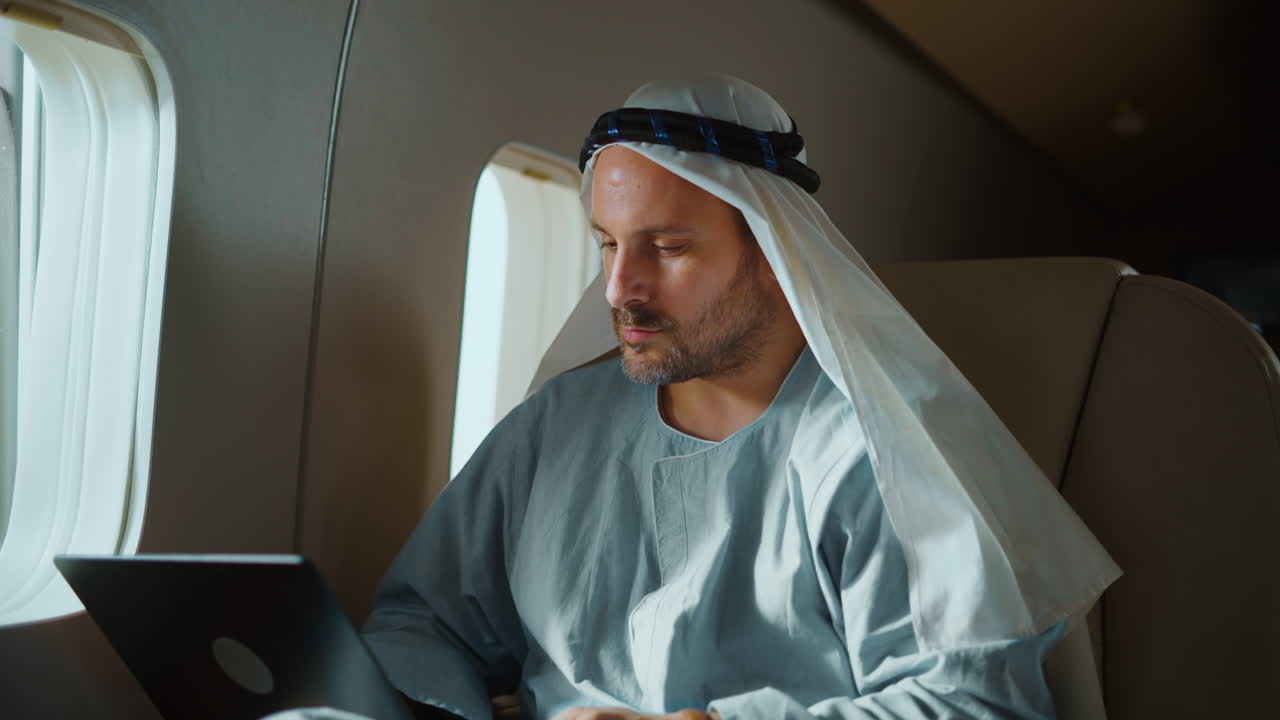 Man working on laptop in private jet