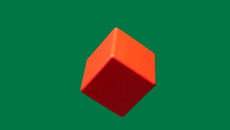 wooden red cube isolated. looped rotation.