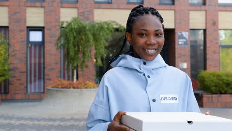 young woman holding pizza boxes