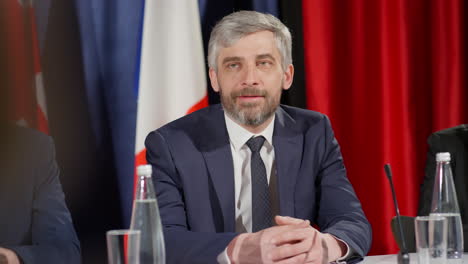political leader answering questions at press conference