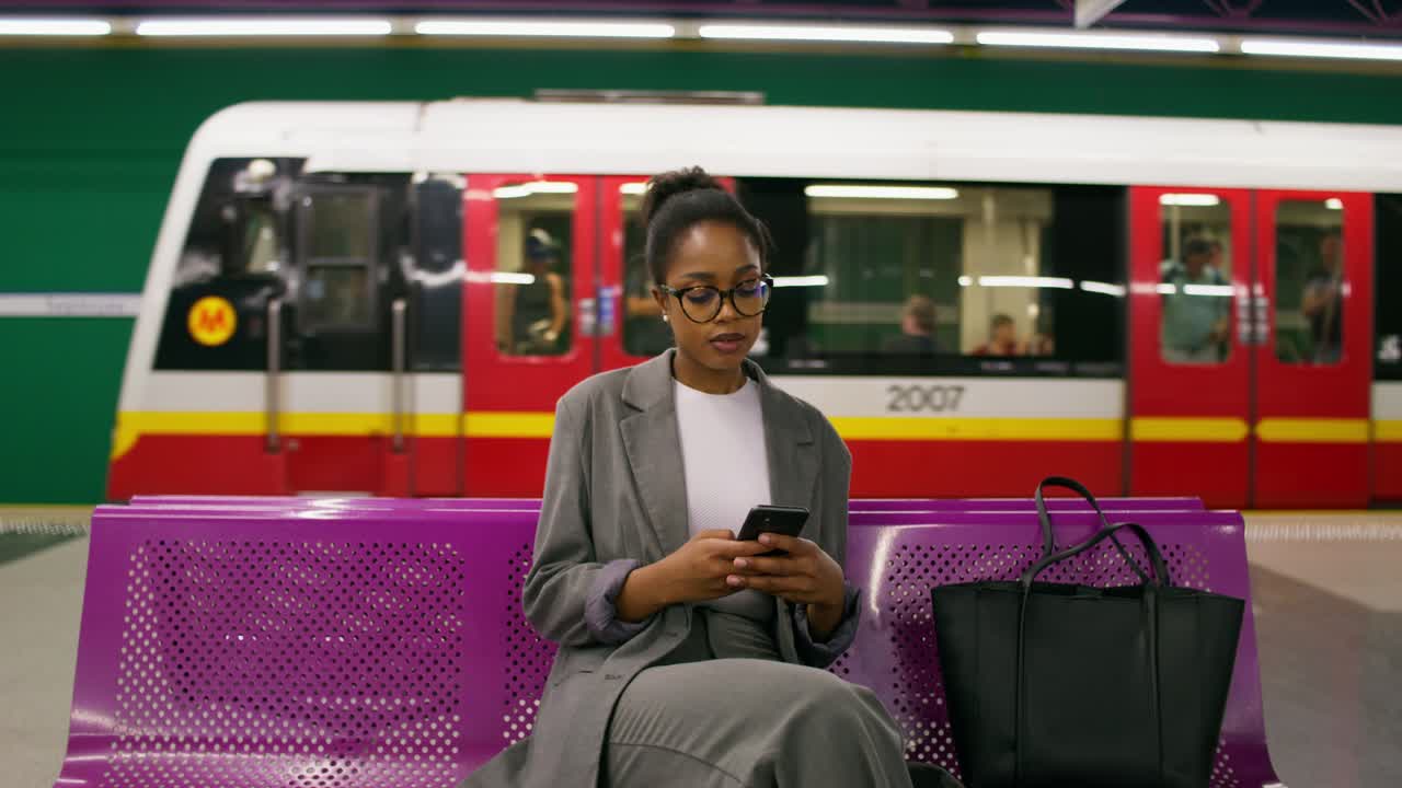 mujer de negocios esperando el tren en la estación de metro
