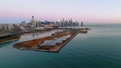 aerial view in front of the northerly island with the chicago cityscape in the background, spring sunrise in usa - tracking, drone shot