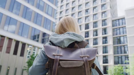 unrecognizable person wearing backpack and visiting the city