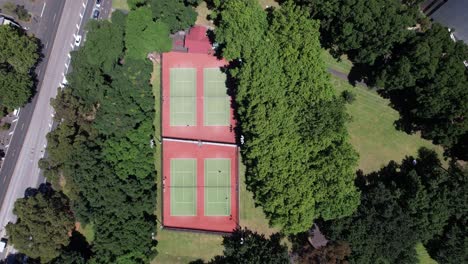 tennis courts surrounded by trees aerial looking straight down