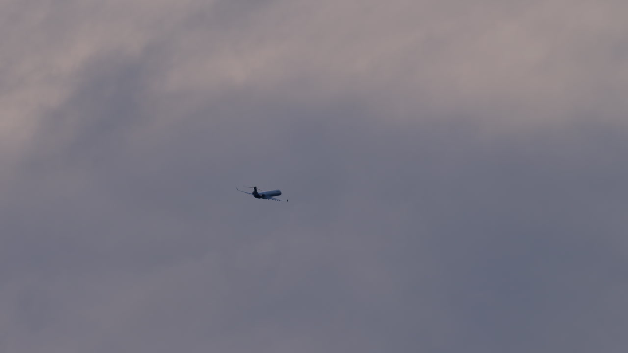 Airplane Flying High Above the Clouds