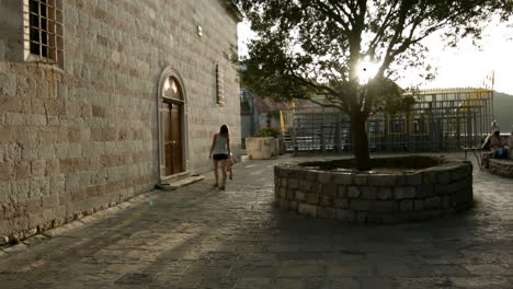 woman walking in an old town plaza