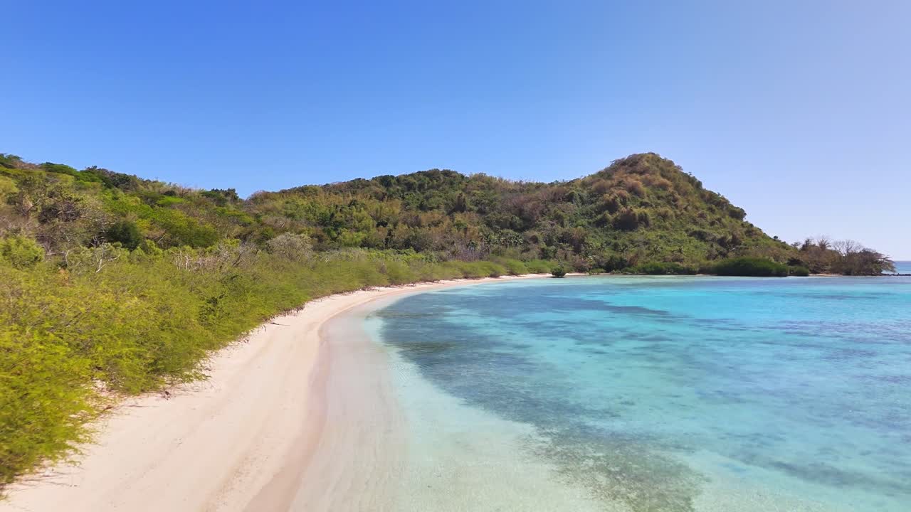 Drone hovering over the crystal clear water in Ditaytayan Island, Philippines