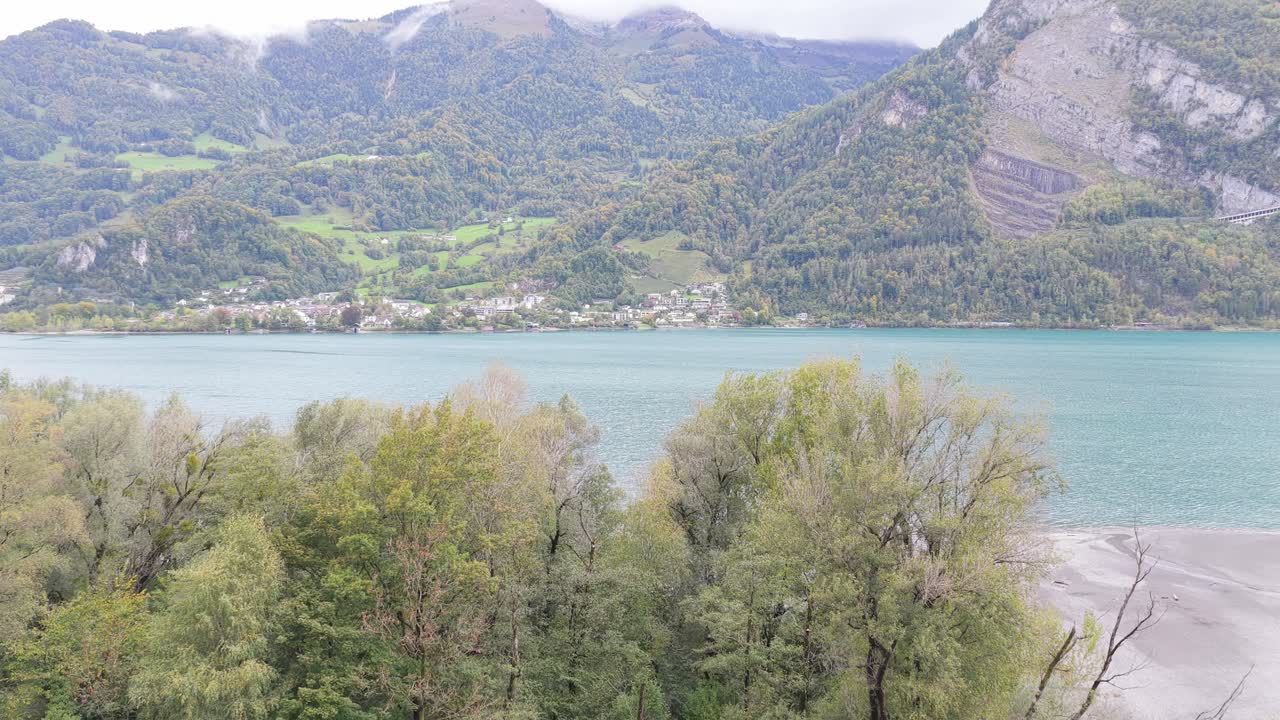 Walensee lake, surrounded by Swiss alps, green hills, and villages of Wessen, Amden, and Quinten, beautiful turquoise water and mountain landscape in Switzerland