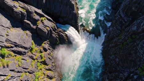 powerful waterfall cascading through a rocky gorge