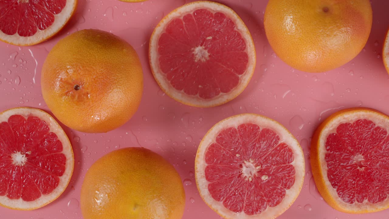 Round slices of grapefruit slowly rotate.