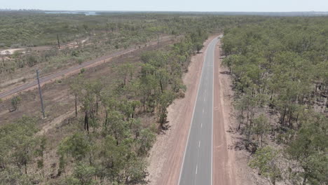 aerial moving drone shot of highway moving to a railway in northern territory, australian outback