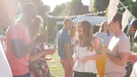 Slow-Motion-Shot-Of-Friends-Enjoying-Drinks-At-Summer-Garden-Fete