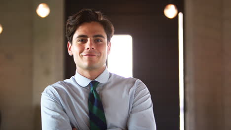 Young-Caucasian-businessman-walking-into-focus-in-office