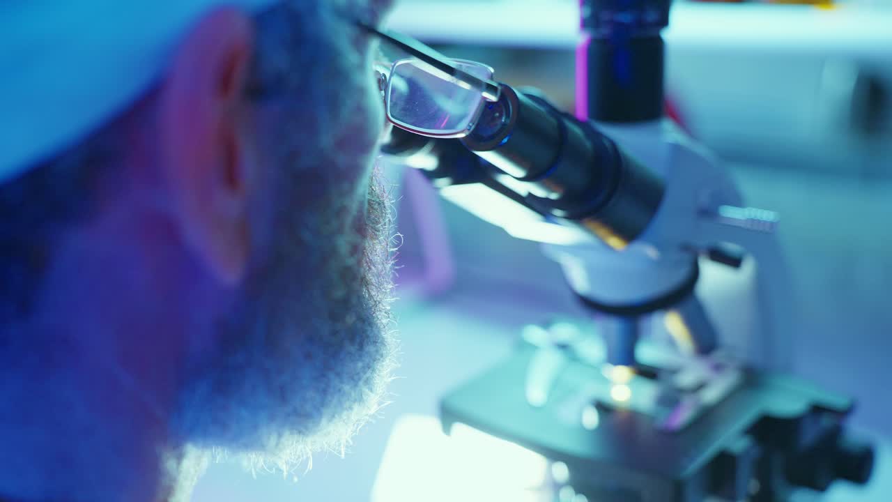 Scientist Looking Through a Microscope in a Modern Laboratory