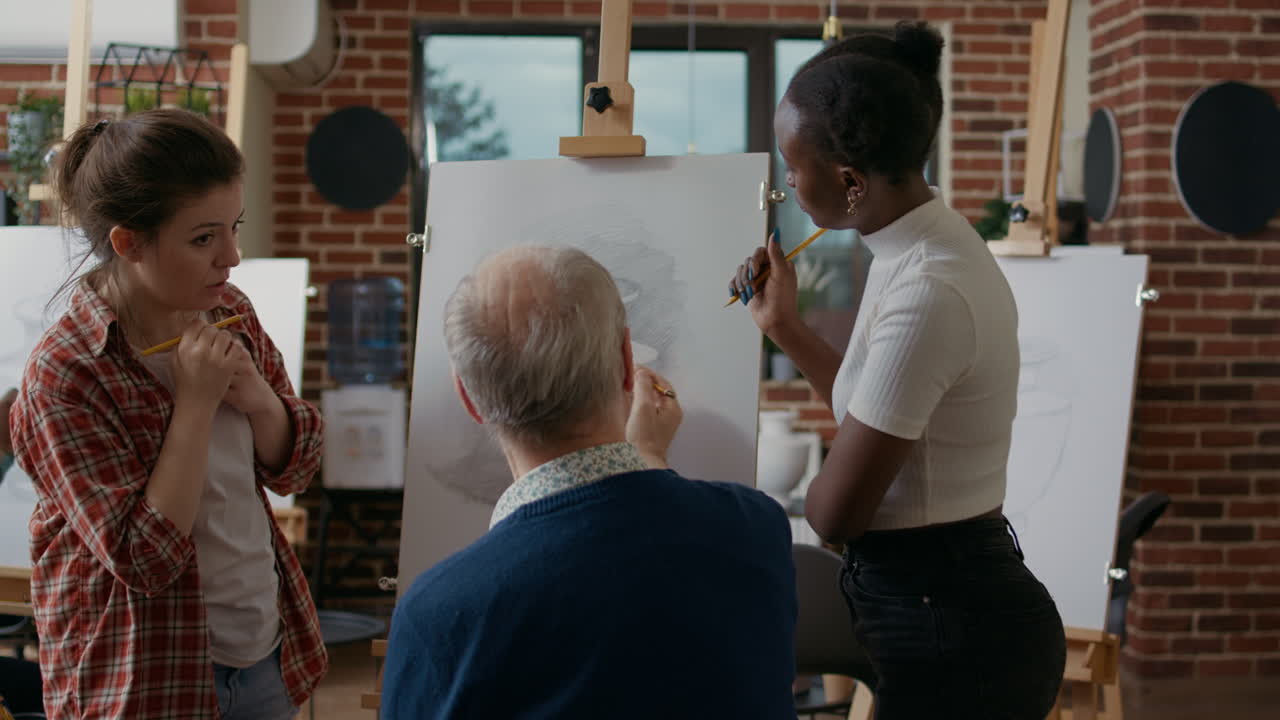 Multiethnic group of people drawing sketch on canvas