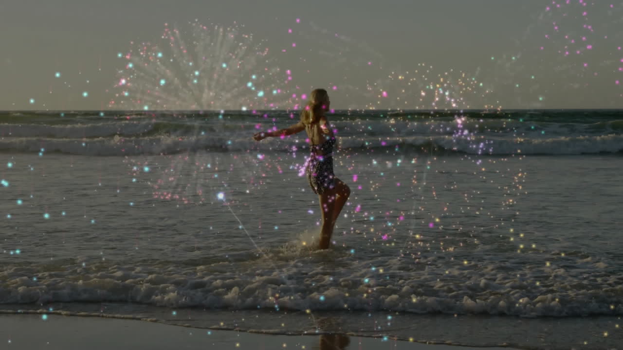 Woman enjoying ocean waves with colorful sparkles animation over scene