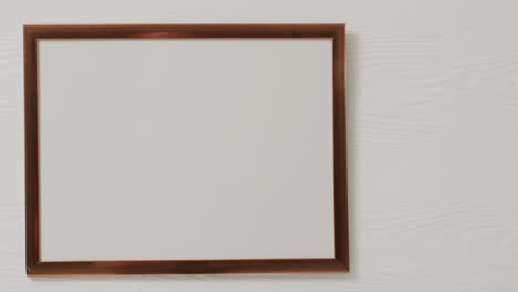 Wooden-frame-with-copy-space-with-white-background-and-white-wall