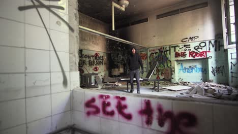 man-black-dressed-lay-down-a-bed-in-abandoned-asylum