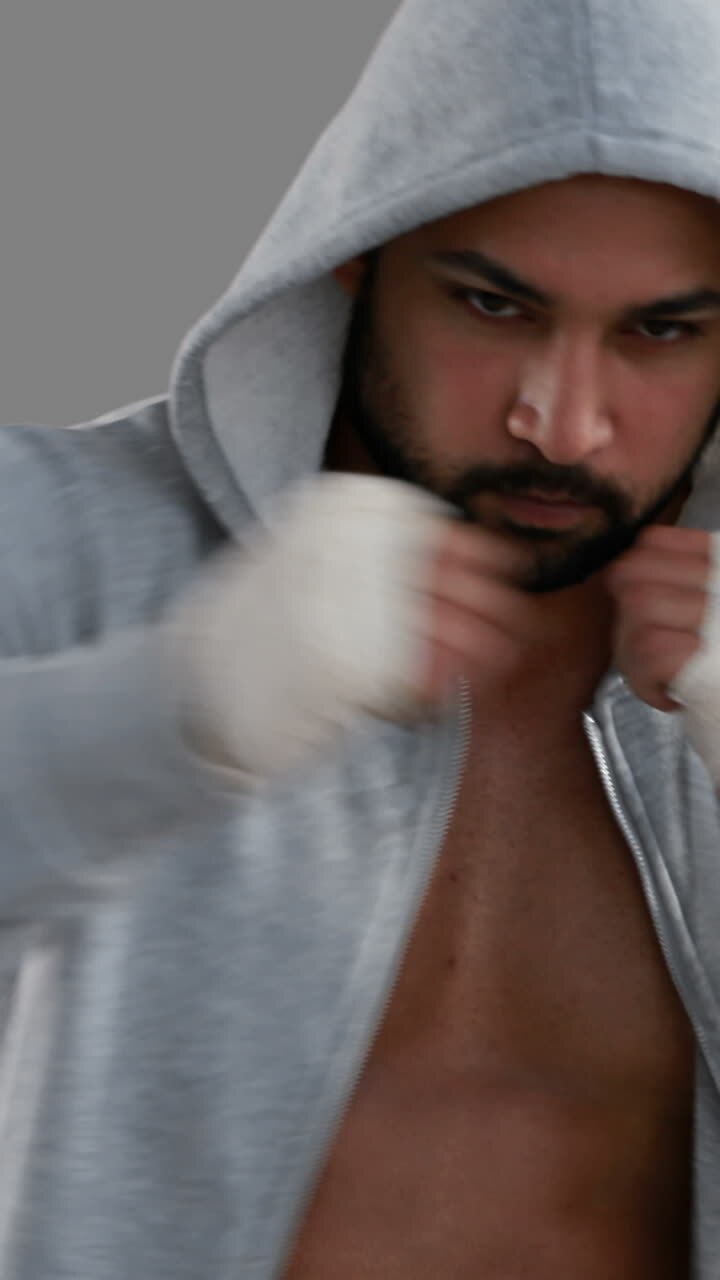 Muscular man wearing grey hood