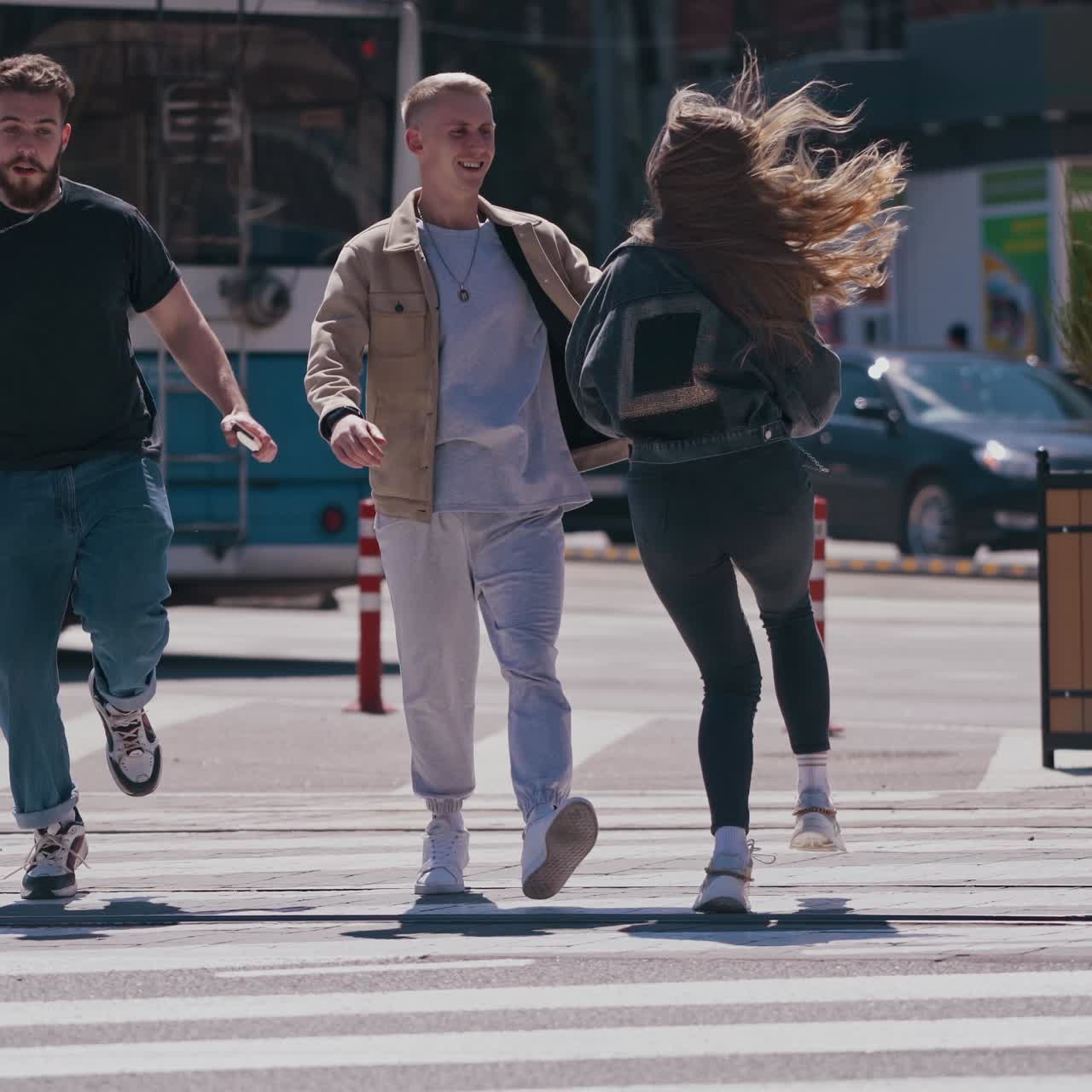 Happy friends meeting at the street. Group of young people having fun outdoors. Guys enjoy their life together