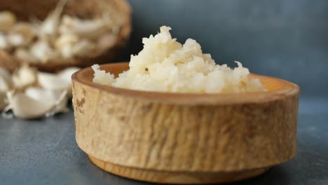 minced garlic in a wooden bowl