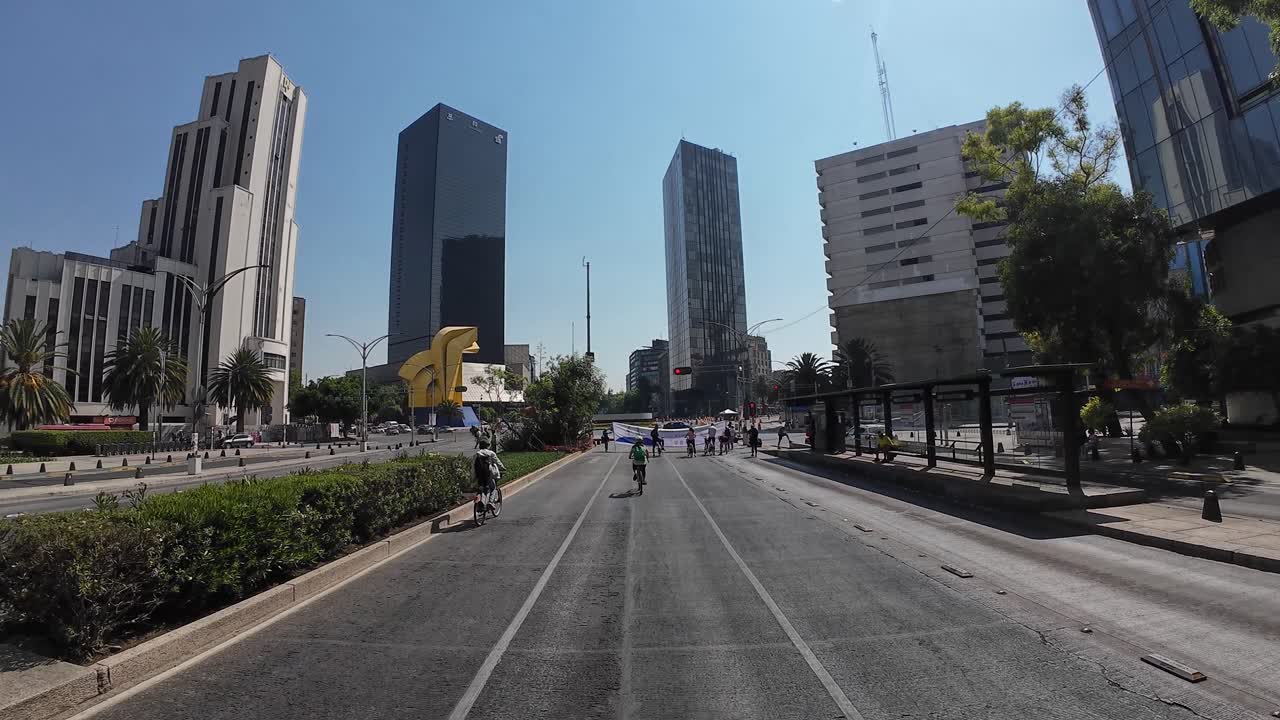 Shot of a woman with her bicycle in reforma avenue mexico city at morning