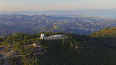 aerial orbit shot of science observatory on top