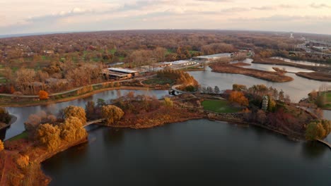 glencoe, illinois, usa : aerial drone forward moving shot over chicago botanic garden during dry autumn season with small lakes during evening time