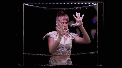 Slow-motion-Girl-does-tricks-with-soap-bubbles-She-plays-by-her-hands-on-soap-wall-with-iridescent-reflected-light