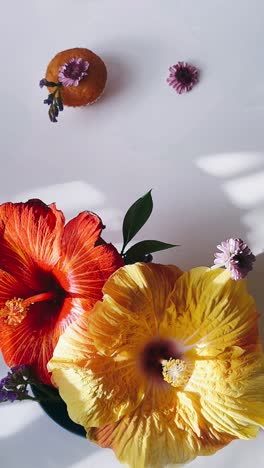 colorful hibiscus and cupcake arrangement