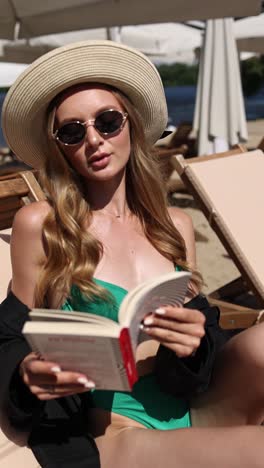 woman reading book on beach