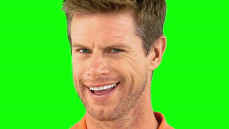 cheerful man winking an eye on green screen