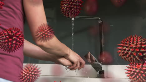 animación de células de macro coronavirus covid-19 que se propagan sobre una mujer caucásica lavándose las manos