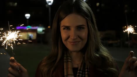 woman with sparklers at night