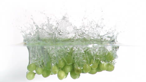 grapes falling into water in super slow motion