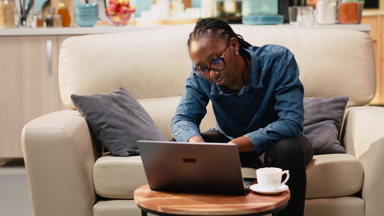 Bored indifferent black girl using laptop with low energy and burnout