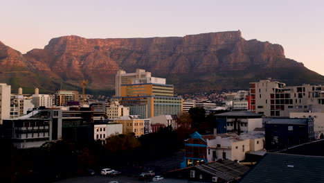 flat-topped table mountain glowing at sunset, towering over cape town