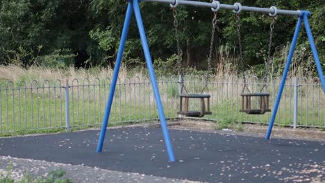 swing moving in an empty park