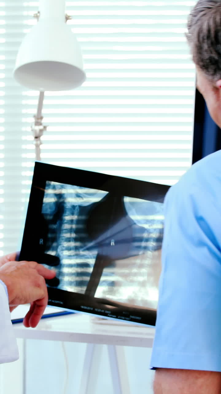 Male doctor discussing x-ray report with a patient