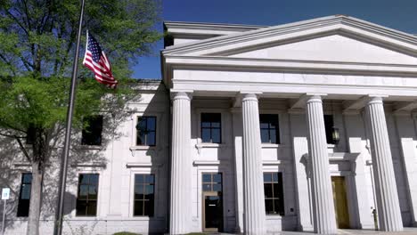 american flag flying outside of arkansas state supreme court building in little rock, arkansas with stable video