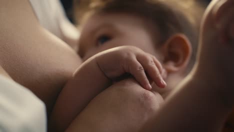 Selective-focus-of-Asian-baby-breastfed-by-mother.