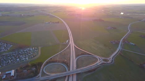 aerial view of freeway intersection with moving traffic cars.