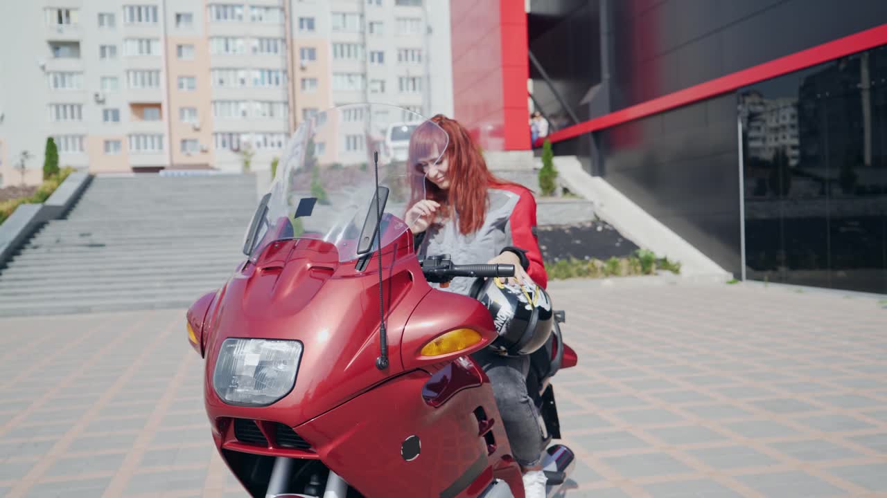 Motorcycle biker girl. Outdoor lifestyle portrait of sexy biker girl sitting on motorcycle