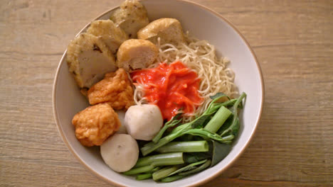 egg noodles with fish balls and shrimp balls in pink sauce, yen ta four or yen ta fo - asian food style