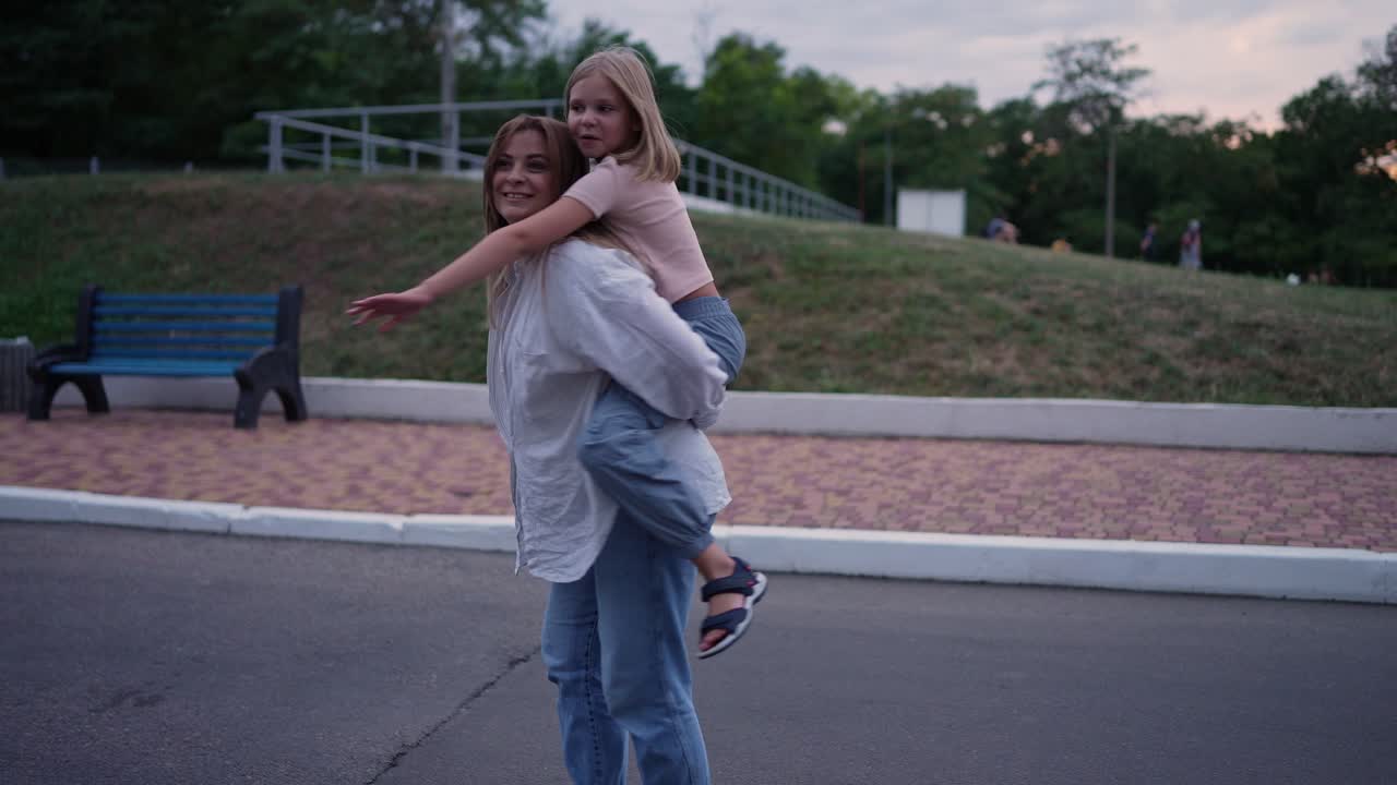 Mother and Daughter Piggyback Ride in Park