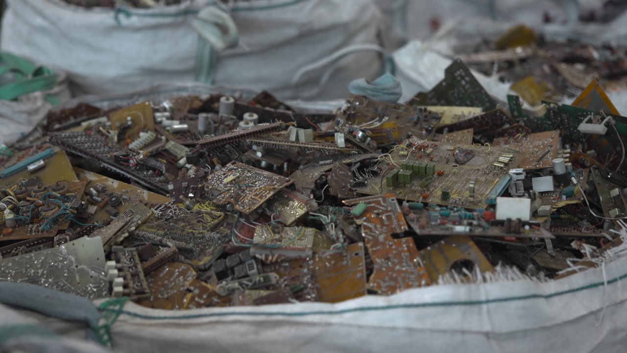 Bulging Sacks Of Electronic Scrap Piled In Warehouse, Closeup Of Mixed PCBs And Components In Large Bag, Ready . Media
