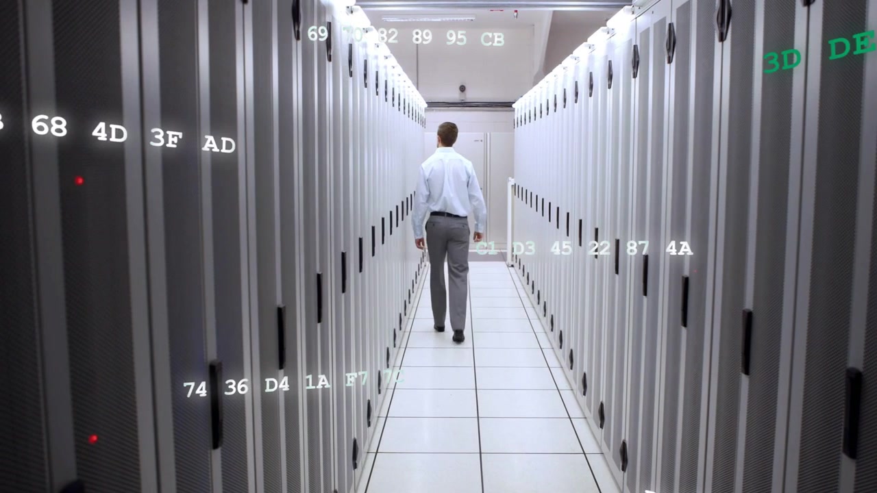 IT engineer walking data center aisle after alert, inspecting and monitoring hex overlays on racks